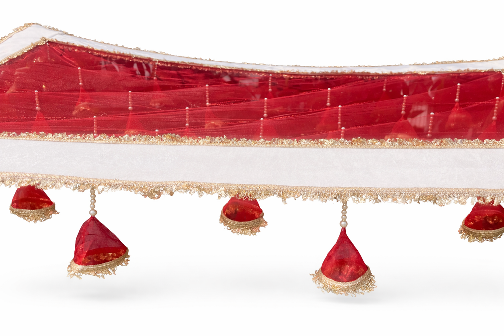 Decorative red fabric with gold trim and red triangular decorations on a white background
