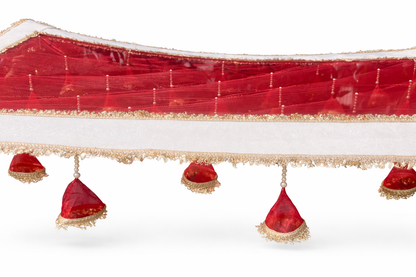 Decorative red fabric with gold trim and red triangular decorations on a white background