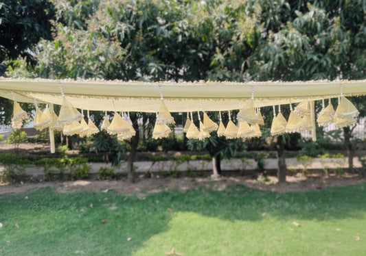 Decorative hanging elements on a string against a green outdoor background
