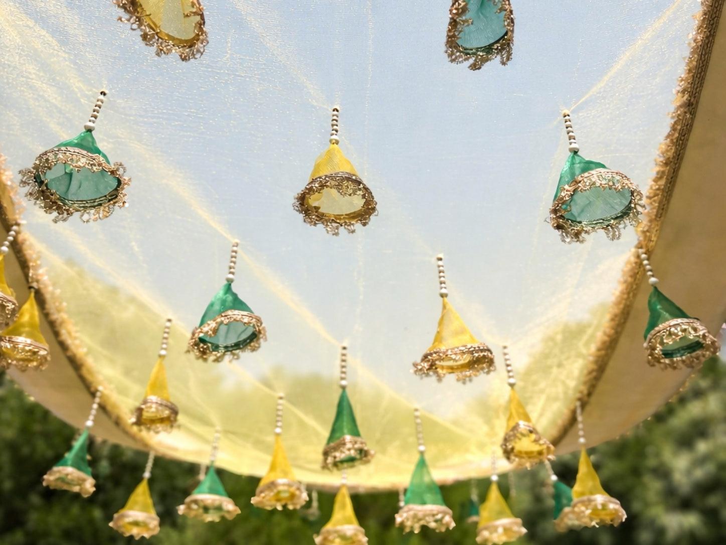 Decorative canopy with green and gold elements against a blue sky