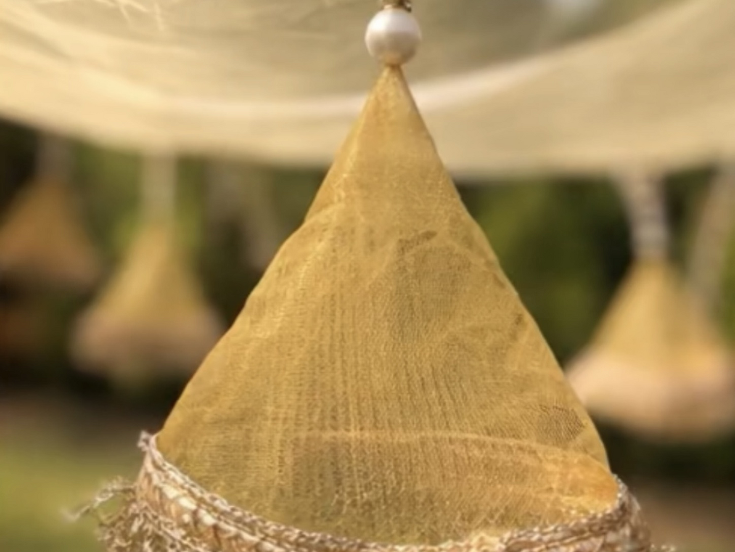 Textured yellow cone-shaped object with a blurred background
