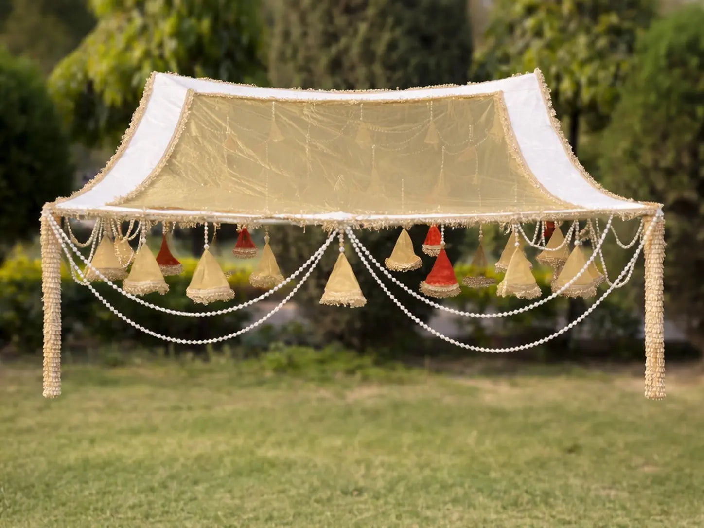 Decorative canopy with hanging lights on a grassy area