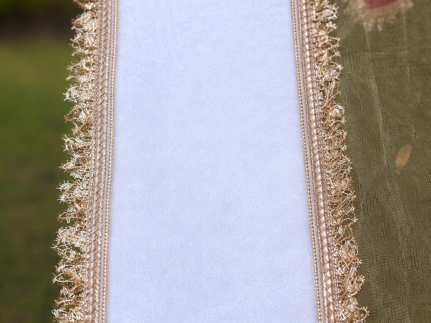 Close-up of decorative gold lace on a fabric background