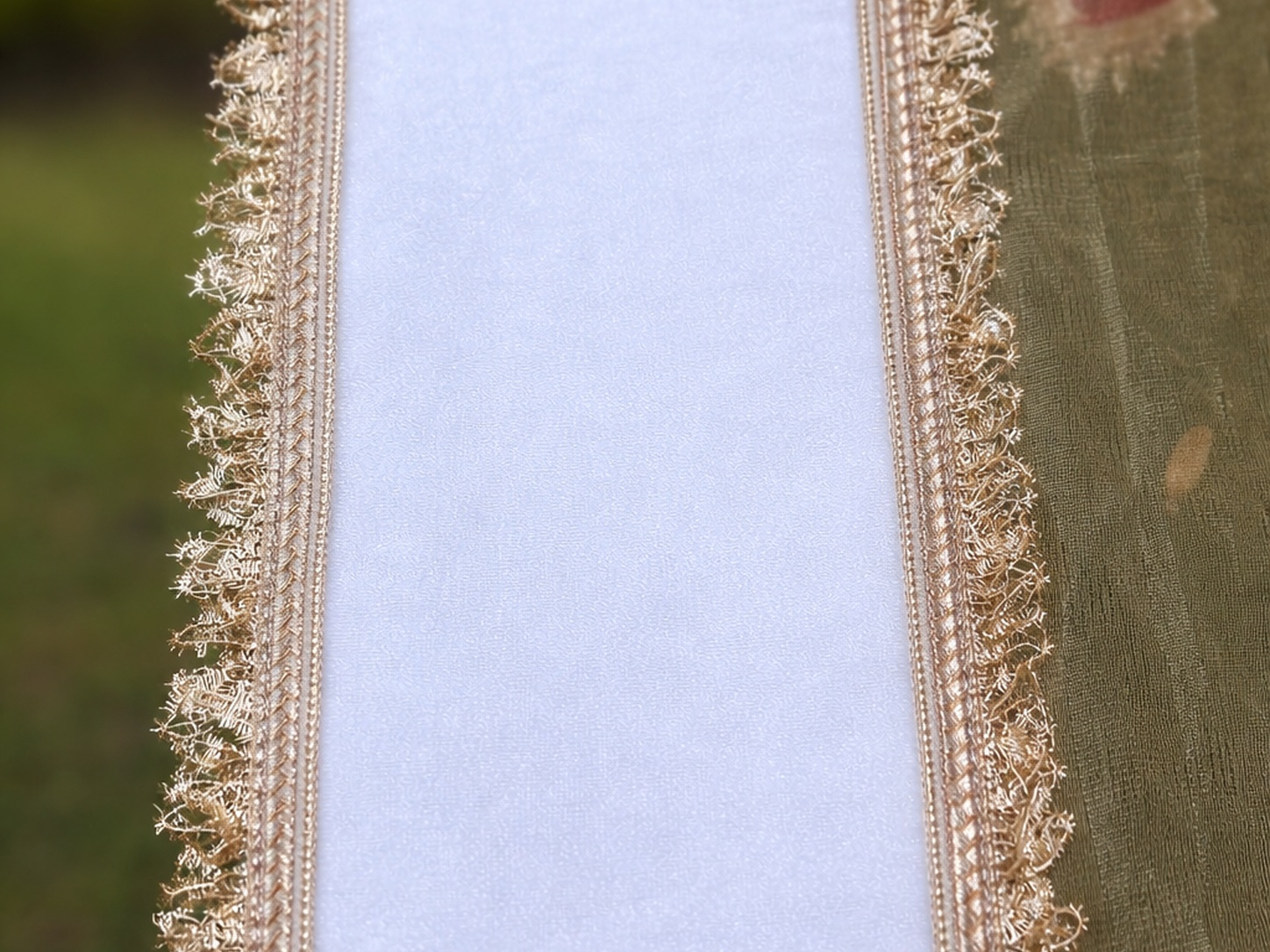 Close-up of decorative gold lace on a fabric background