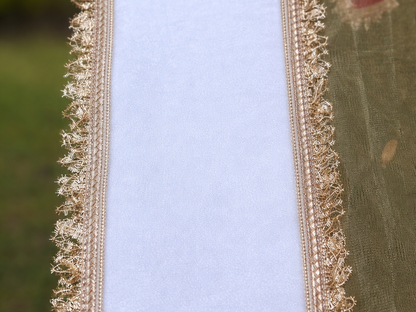 Close-up of decorative gold lace on a fabric background